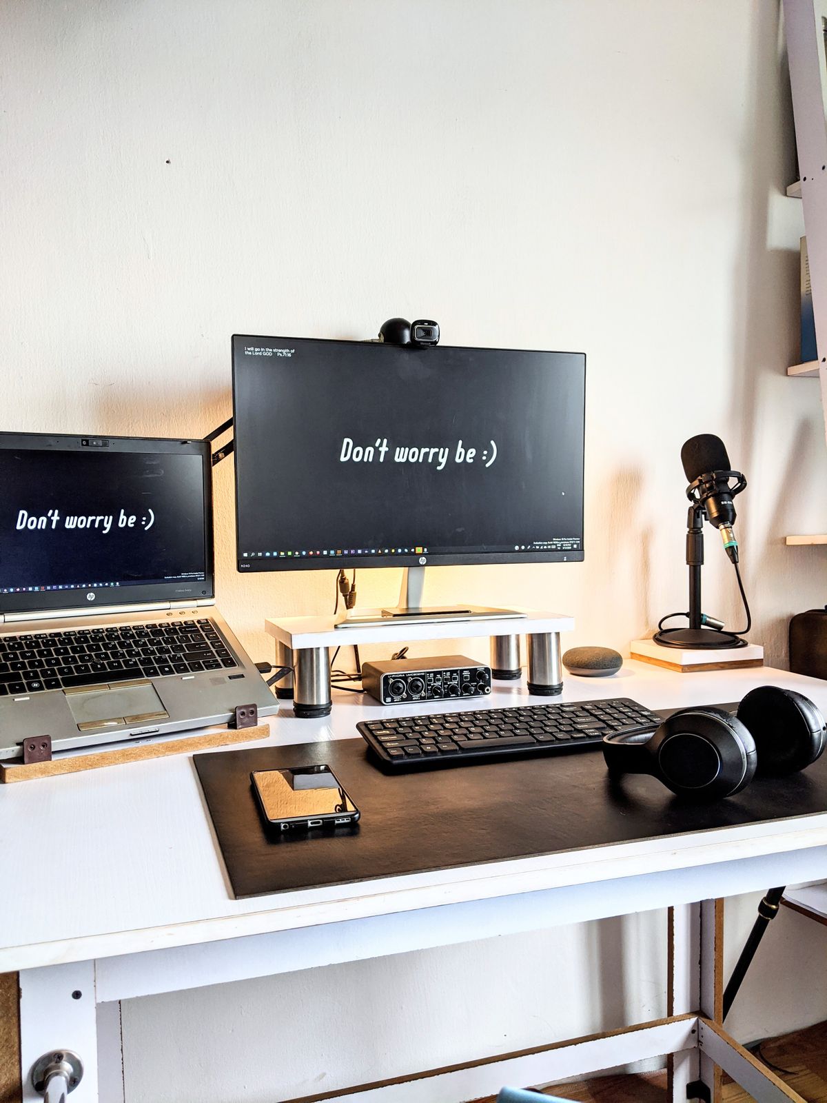 A tidy home office workspace with laptop, external monitor and organised desk accessories