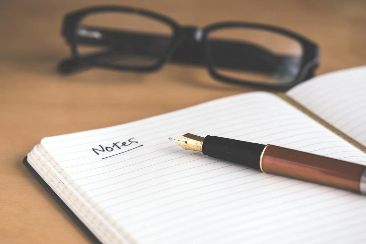 Open notebook with pen on a minimalist desk