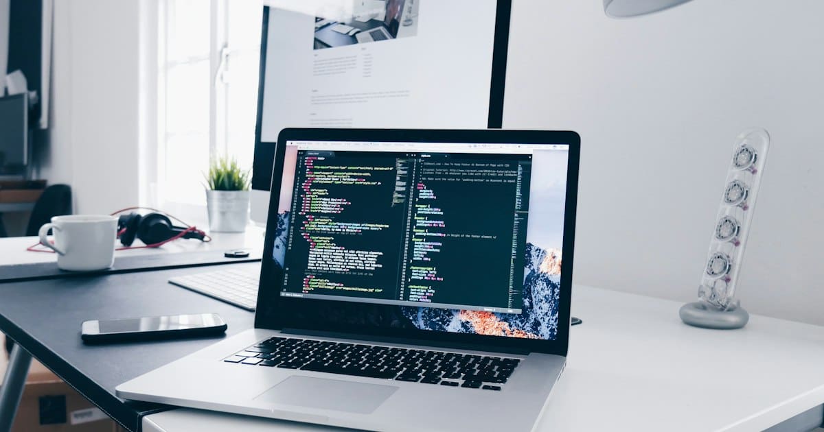 Minimalist home office workspace with a laptop on a clean desk for remote work
