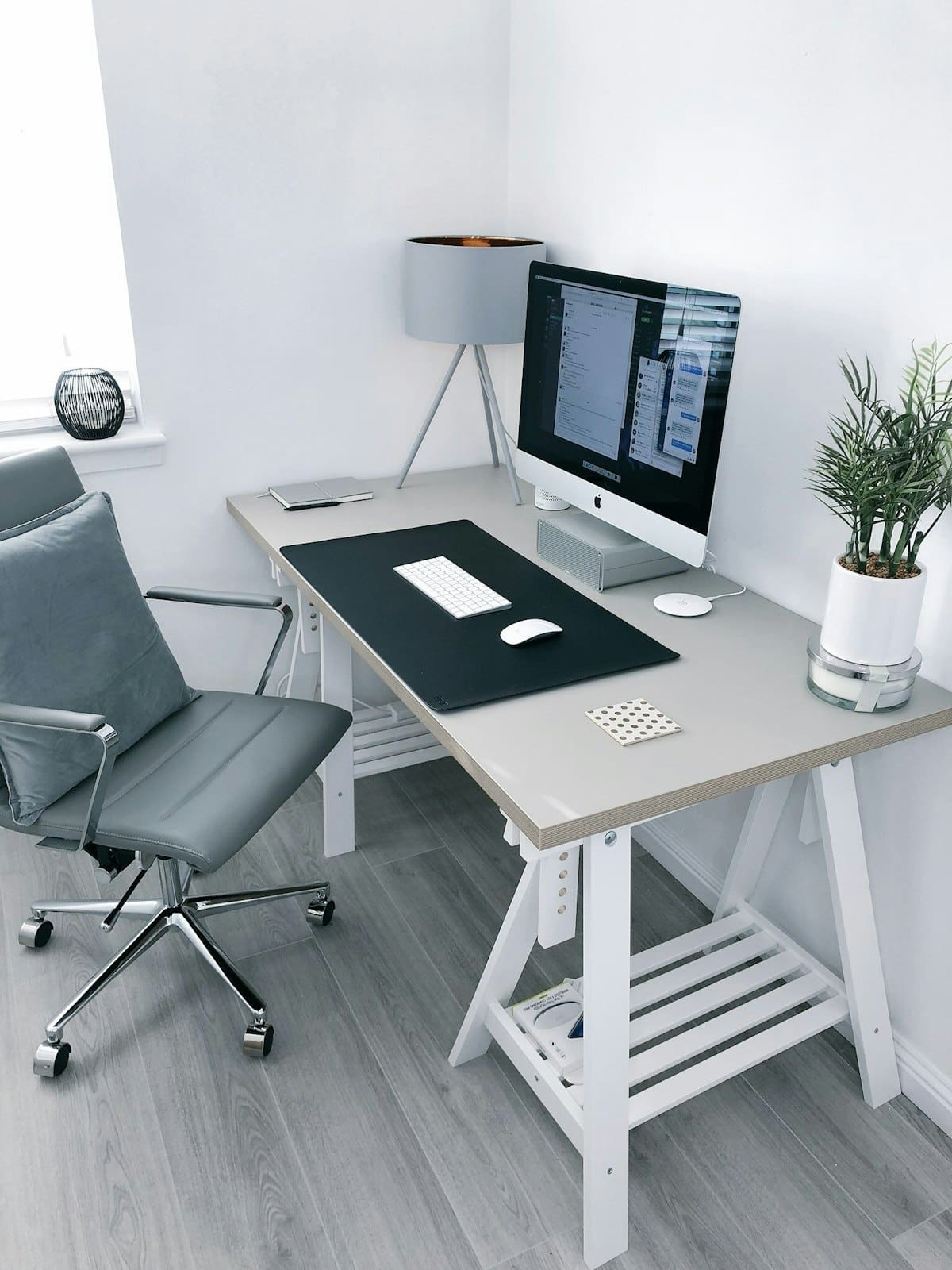 Organised home office desk with ergonomic seating and natural light through the window