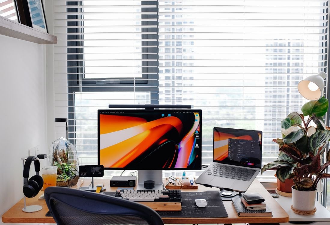 Modern workspace with laptop and external monitor setup on a clean desk